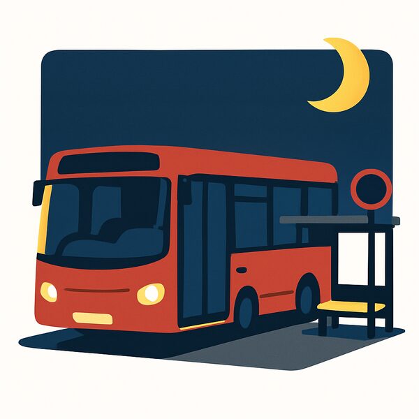 A bus at a bus stop at night